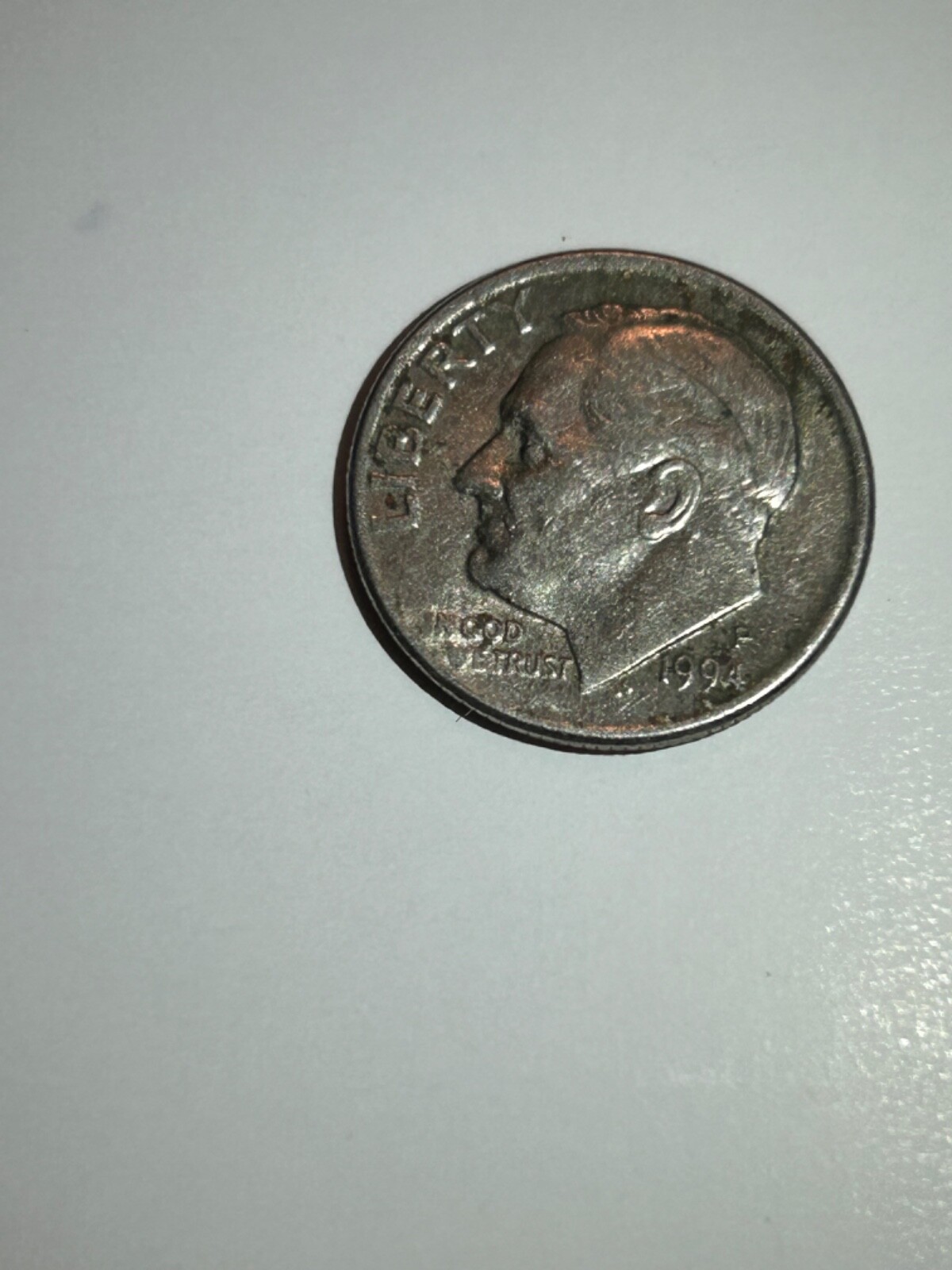 1994 dime missing clad layer error showing copper-colored obverse where the nickel cladding is absent