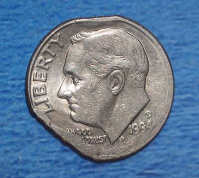1994 dime clipped planchet error showing a curved notch removed from the coin edge where the blank was punched from overlapping strip
